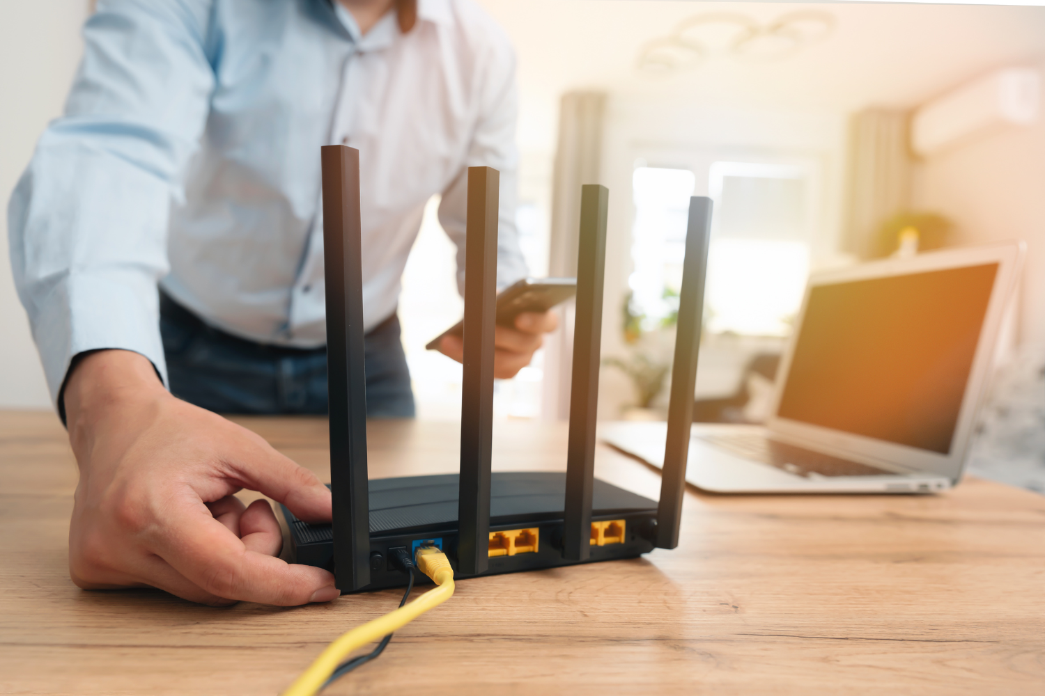 A remote worker experiencing an internet outage and checking internet router.