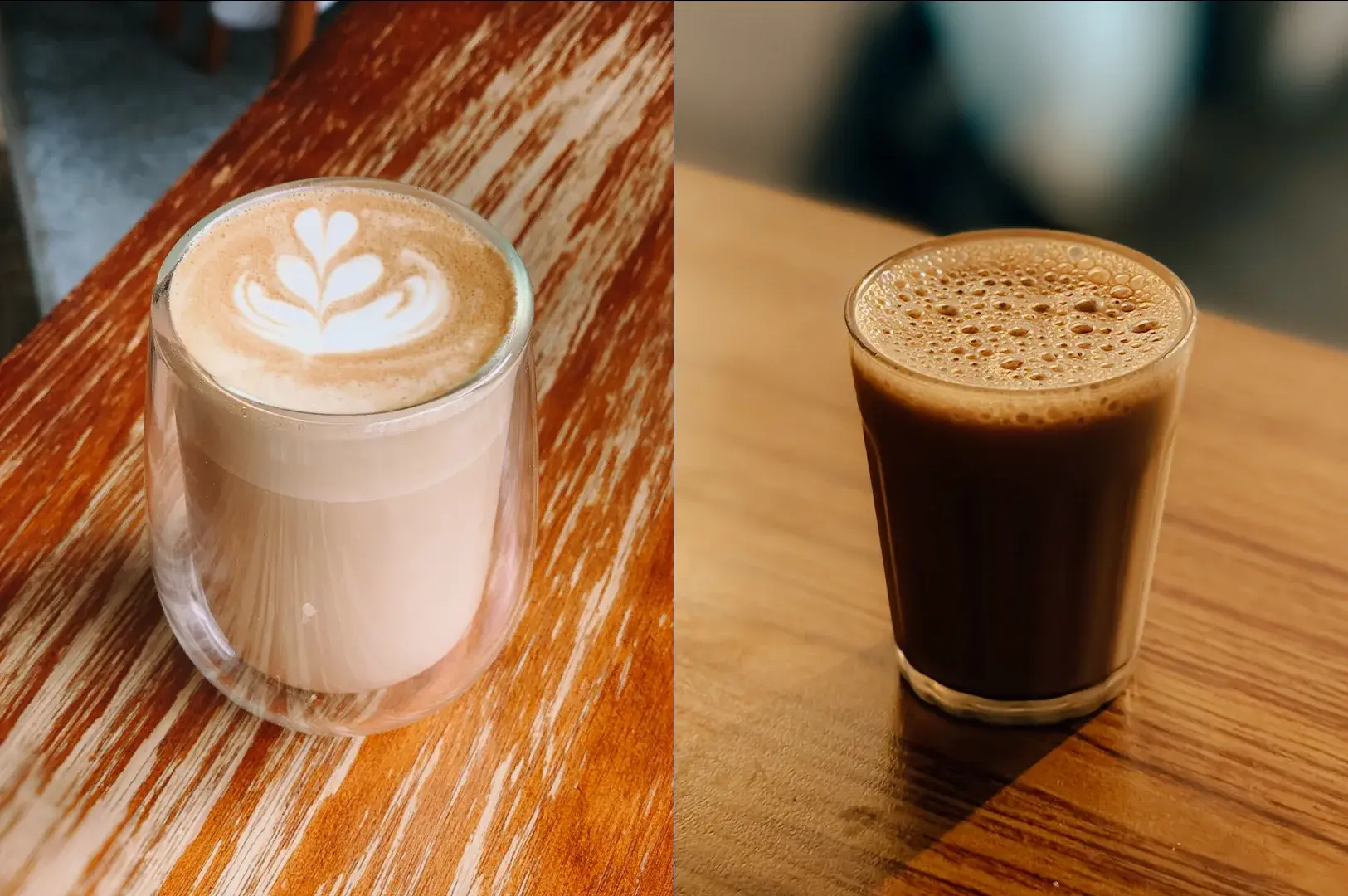 A side-by-side comparison shows a modern, double-walled glass mug containing a pale, foamy latte-style drink with intricate heart-shaped latte art on the left, next to a small, clear glass filled with dark, frothy masala chai on the right, both resting on a wooden table.