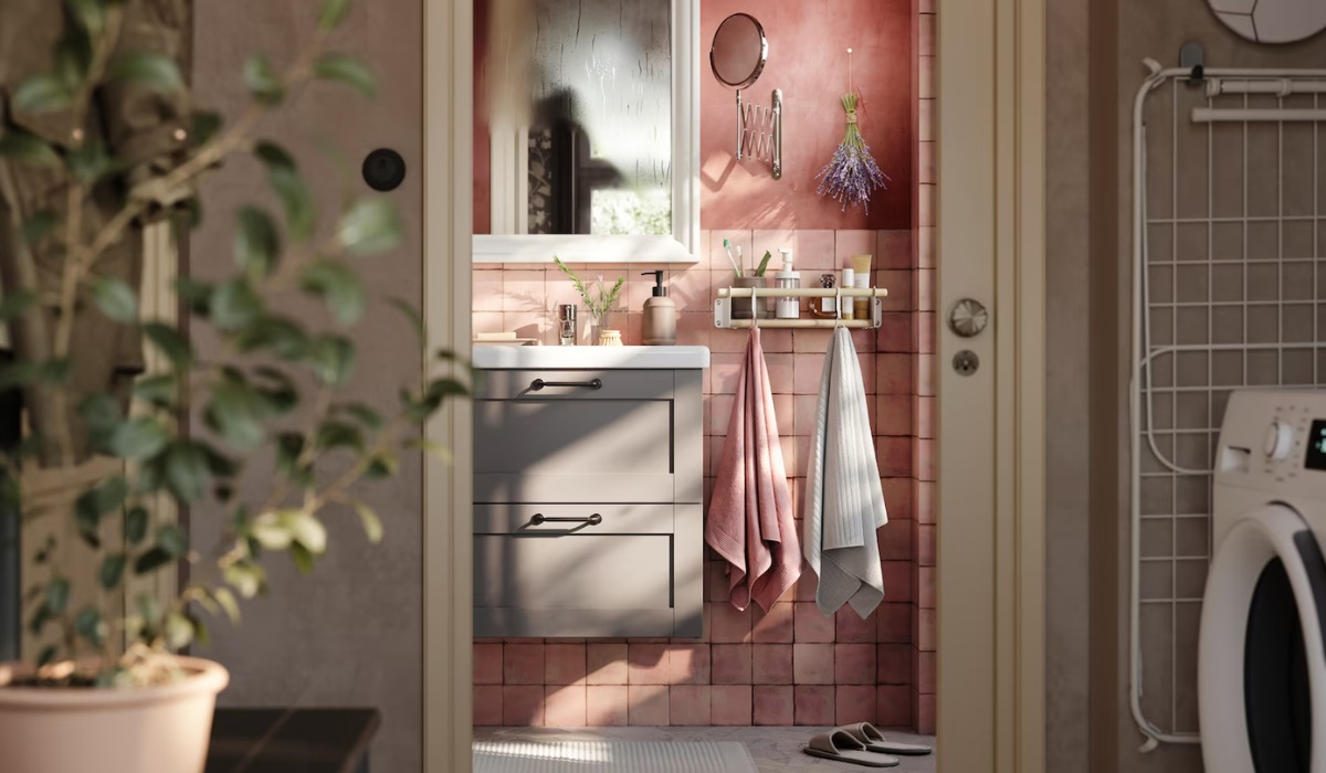 Small bathroom - grey drawer storage - pink walls - white wall cabinets