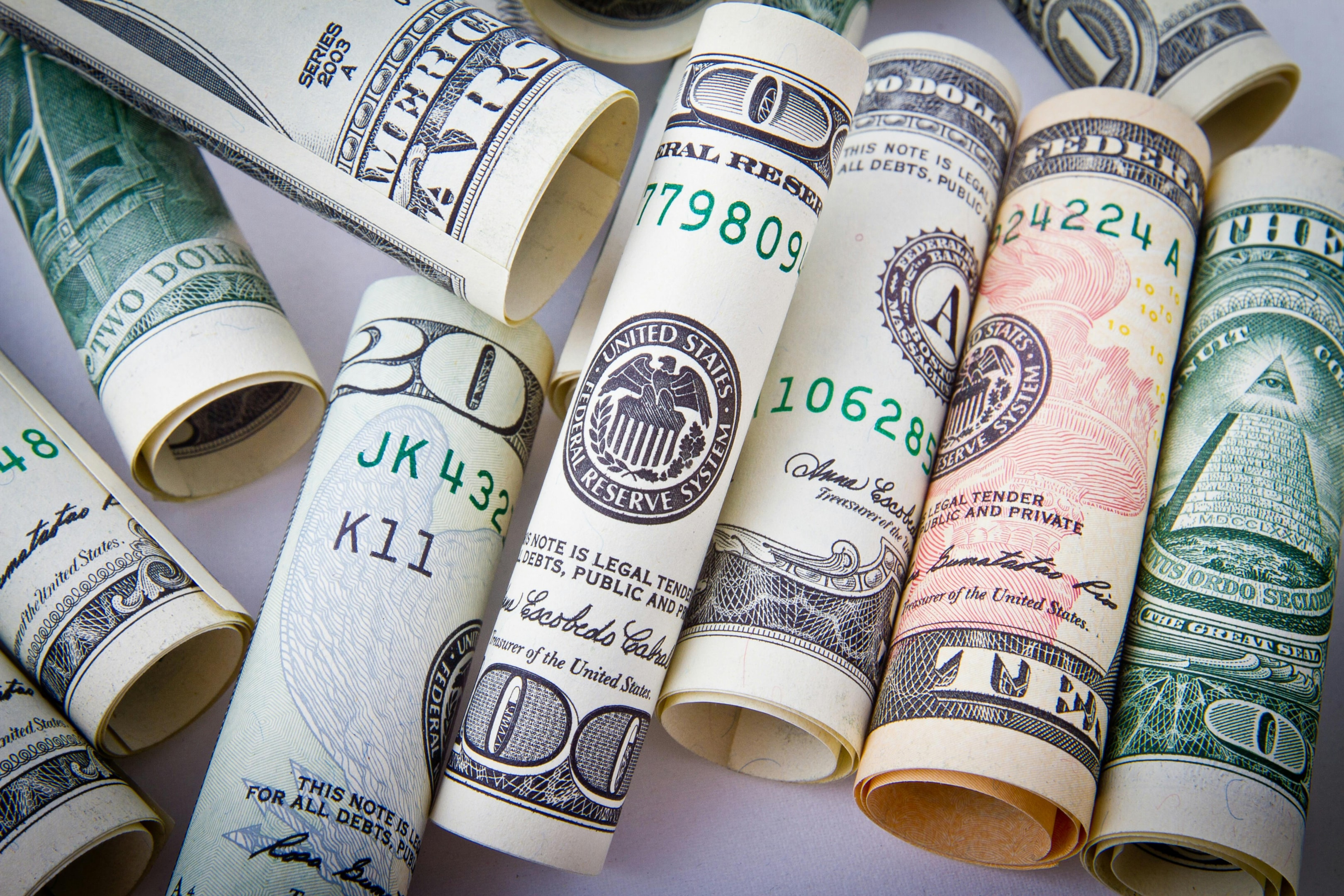 Rolled dollar bills representing financial planning as a real estate investor.