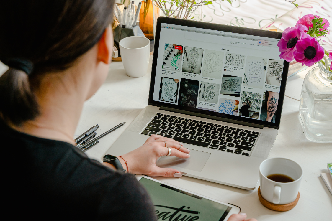 Graphic designer reviewing visual references and design assets on a laptop
