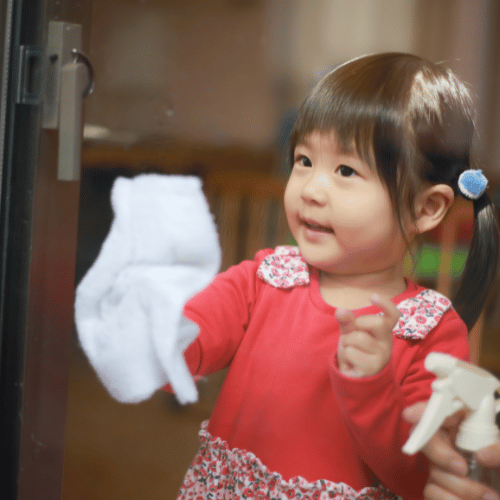 child cleaning a window