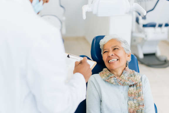 senior dental patient consults with surgeon about dental bone grafting