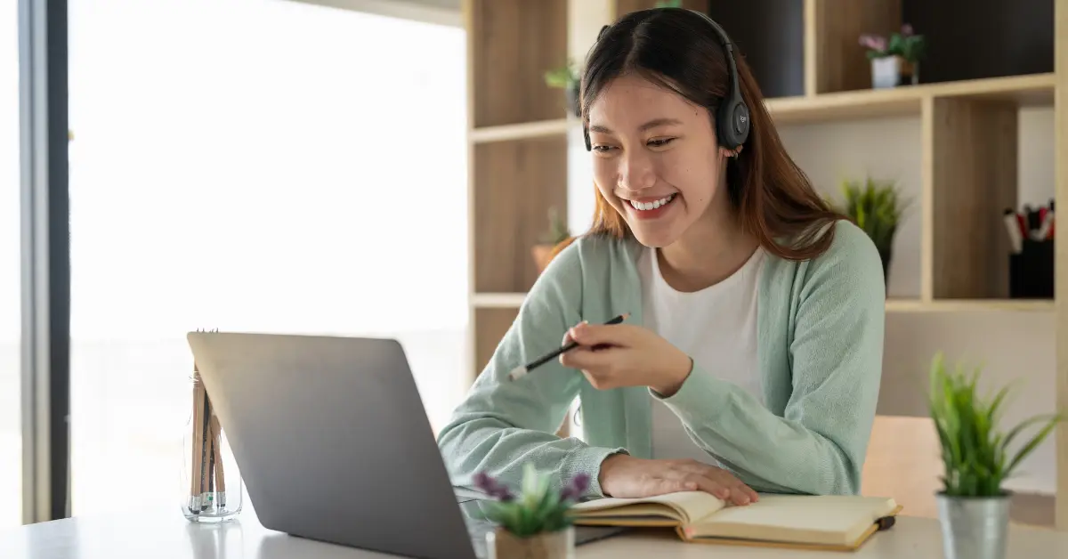 A woman reviewing OnlyFans account details and OnlyFans address for taxes on her laptop.