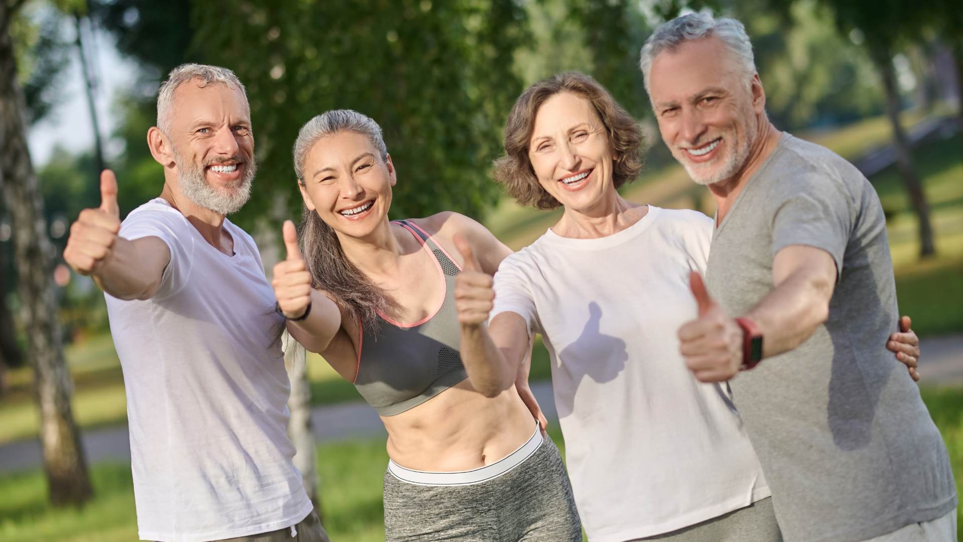 Group of adults giving thumbs up, representing liver health benefits, detoxification process, and reduced risk of liver disease.