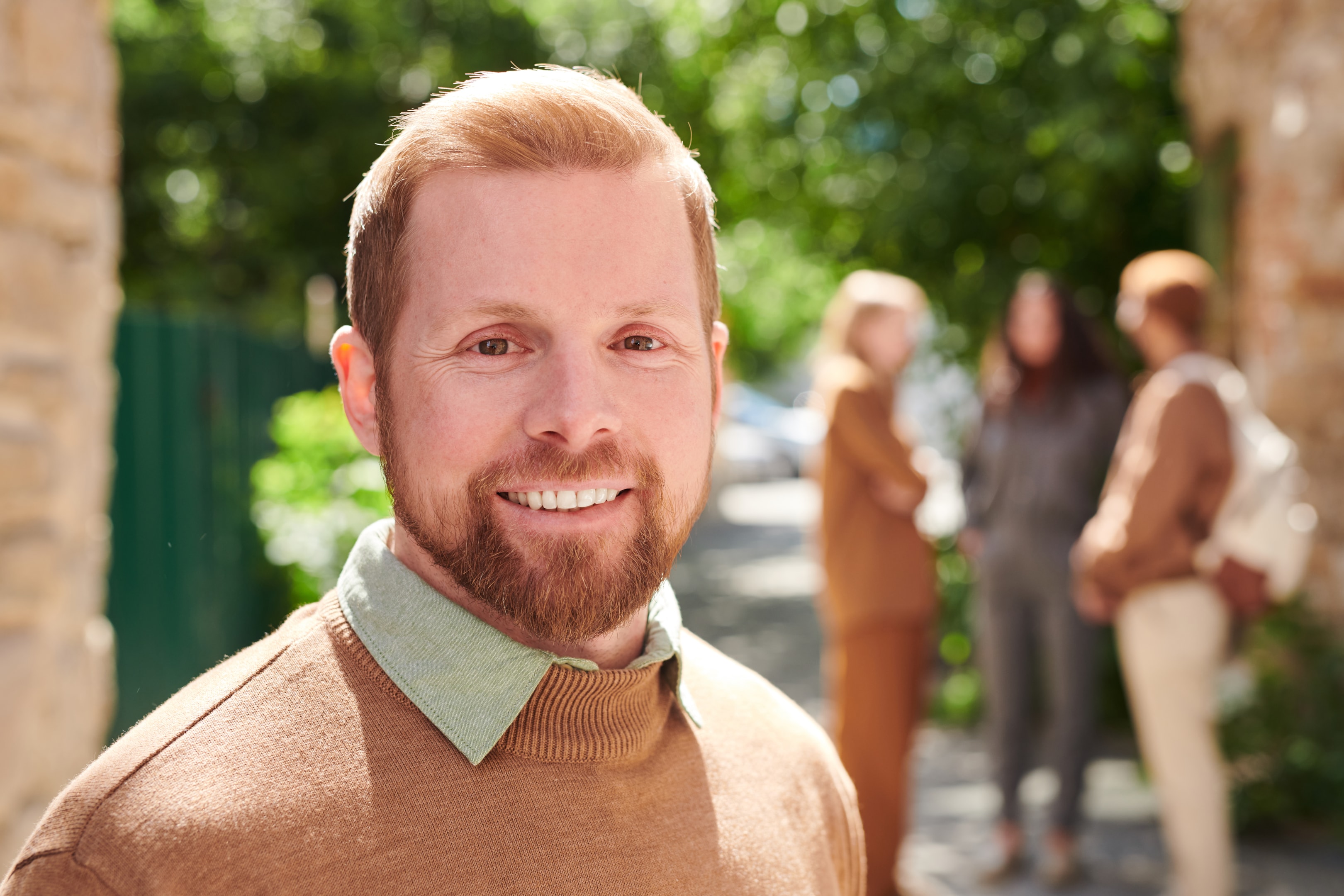 a smiling man who has received a dental bone graft to facilitate a future dental implant