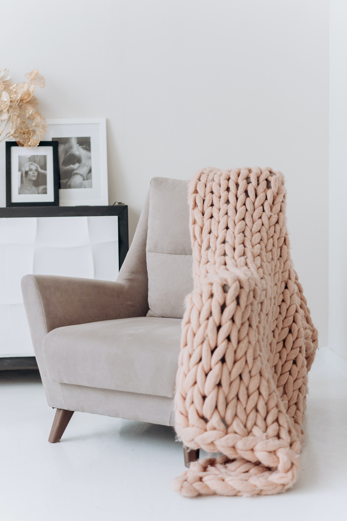 white-and-brown-armchair-beside-white-wall