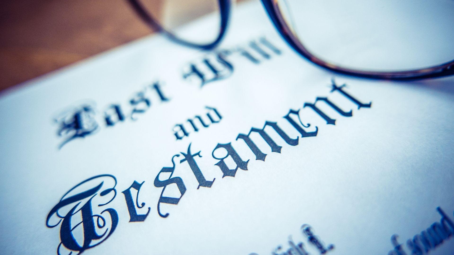 Close-up of a “Last Will and Testament” document with reading glasses resting on top, representing estate planning and legal documentation.