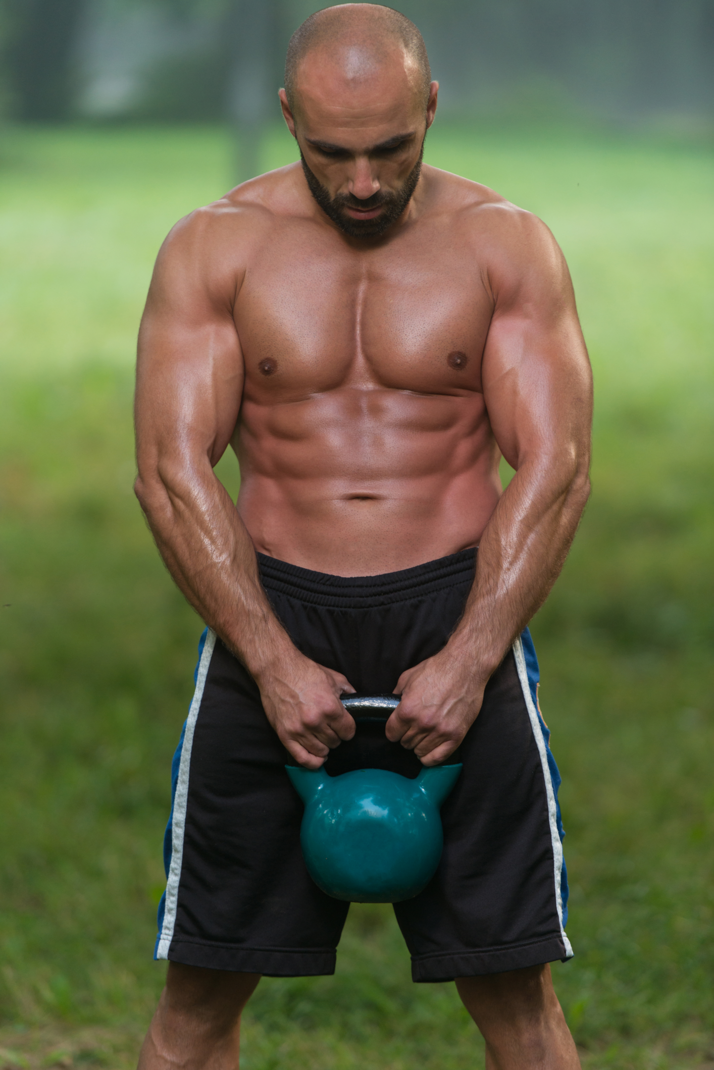 A young athlete practising kettle bell swinging