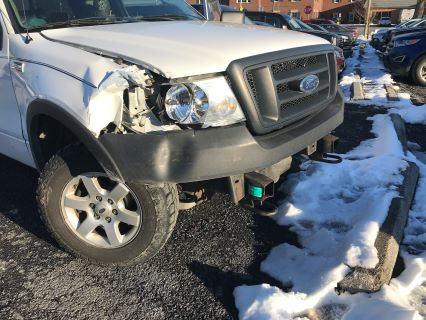 truck with headlight damage after rear end collision