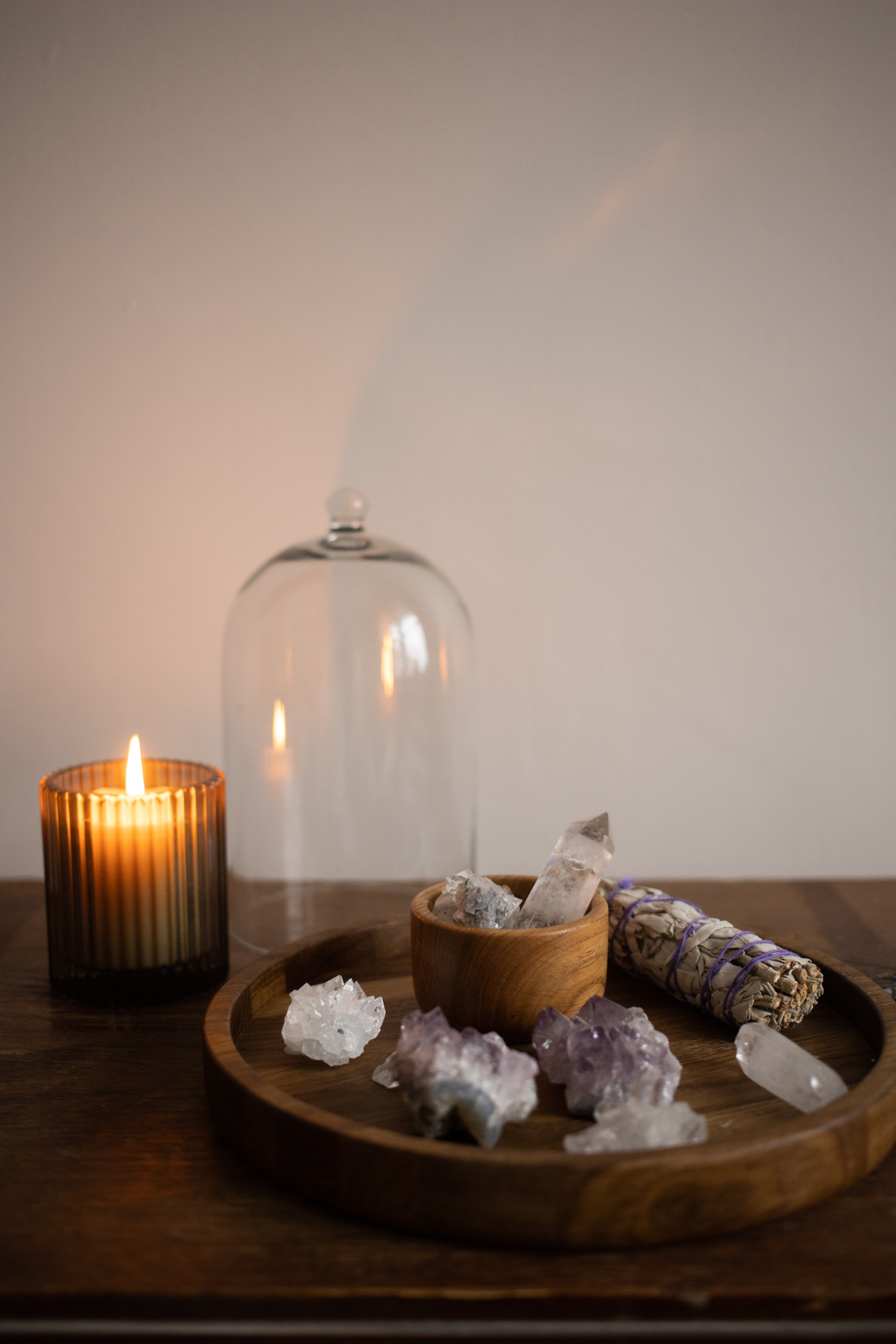 picture of healing crystals next to a lit candle 