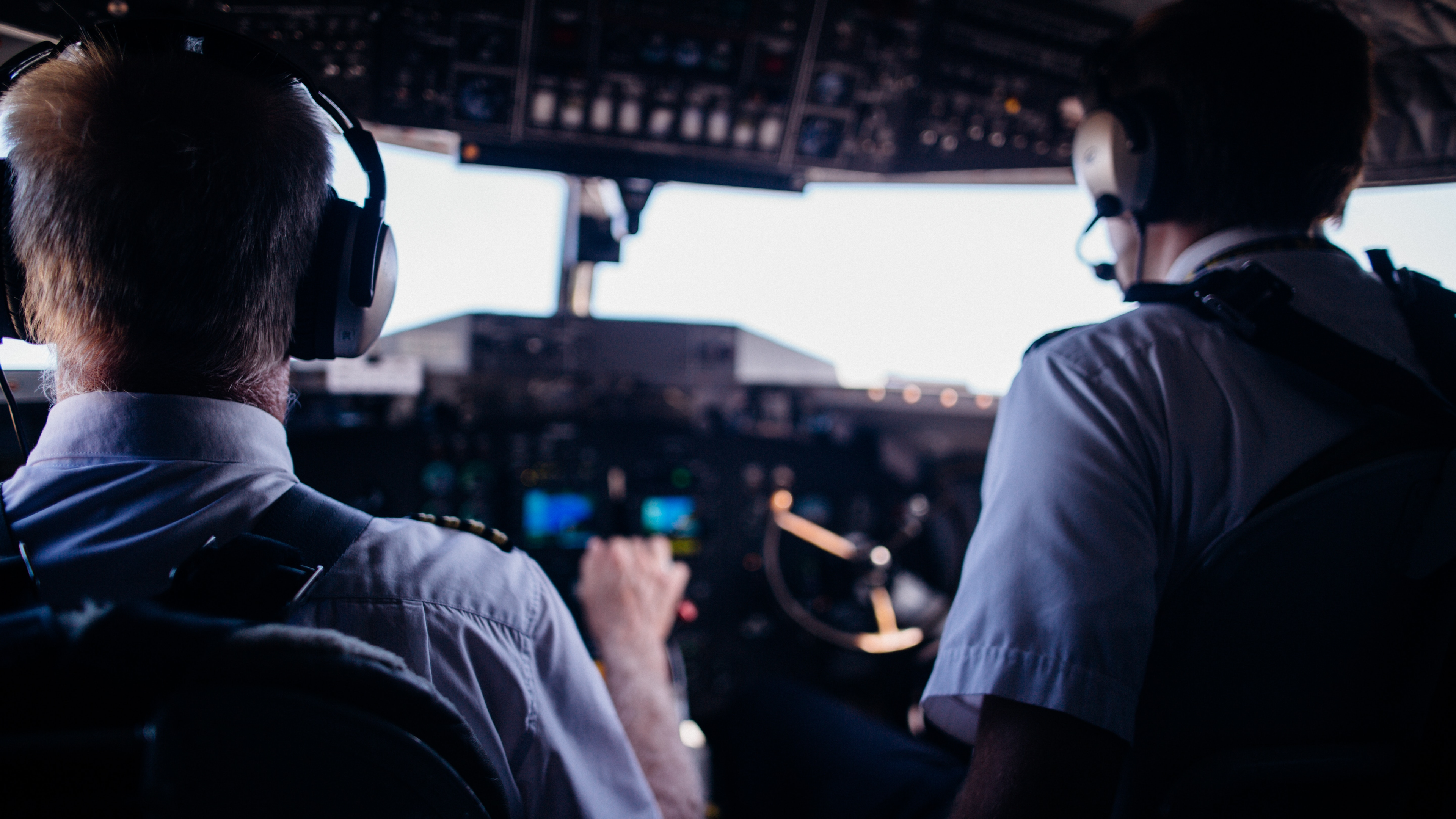 Two pilots controlling an airplane.