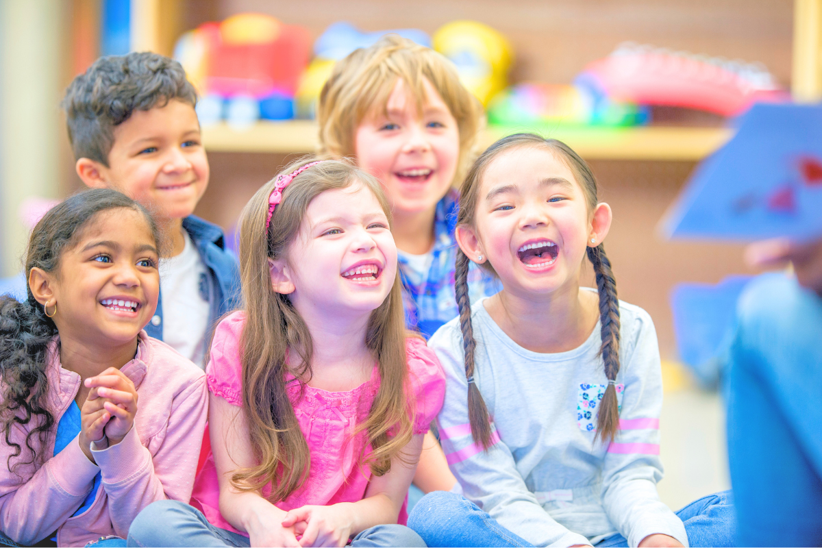 young kids in a group laughing