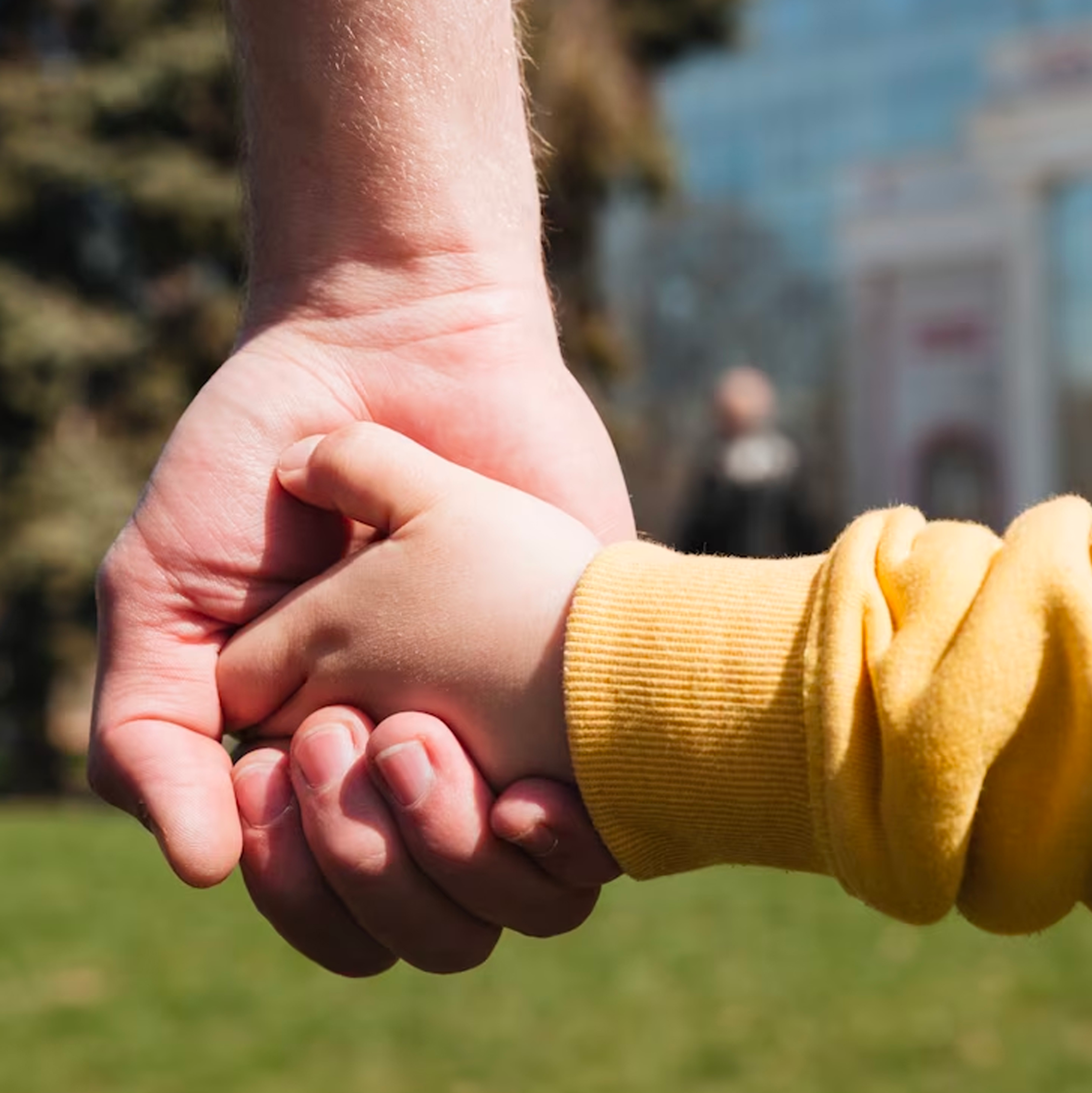 dad holding child hand