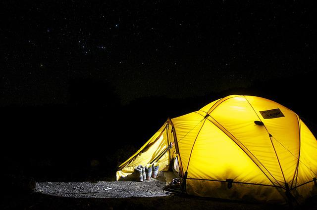 camping in a tent at night in a rustic camp