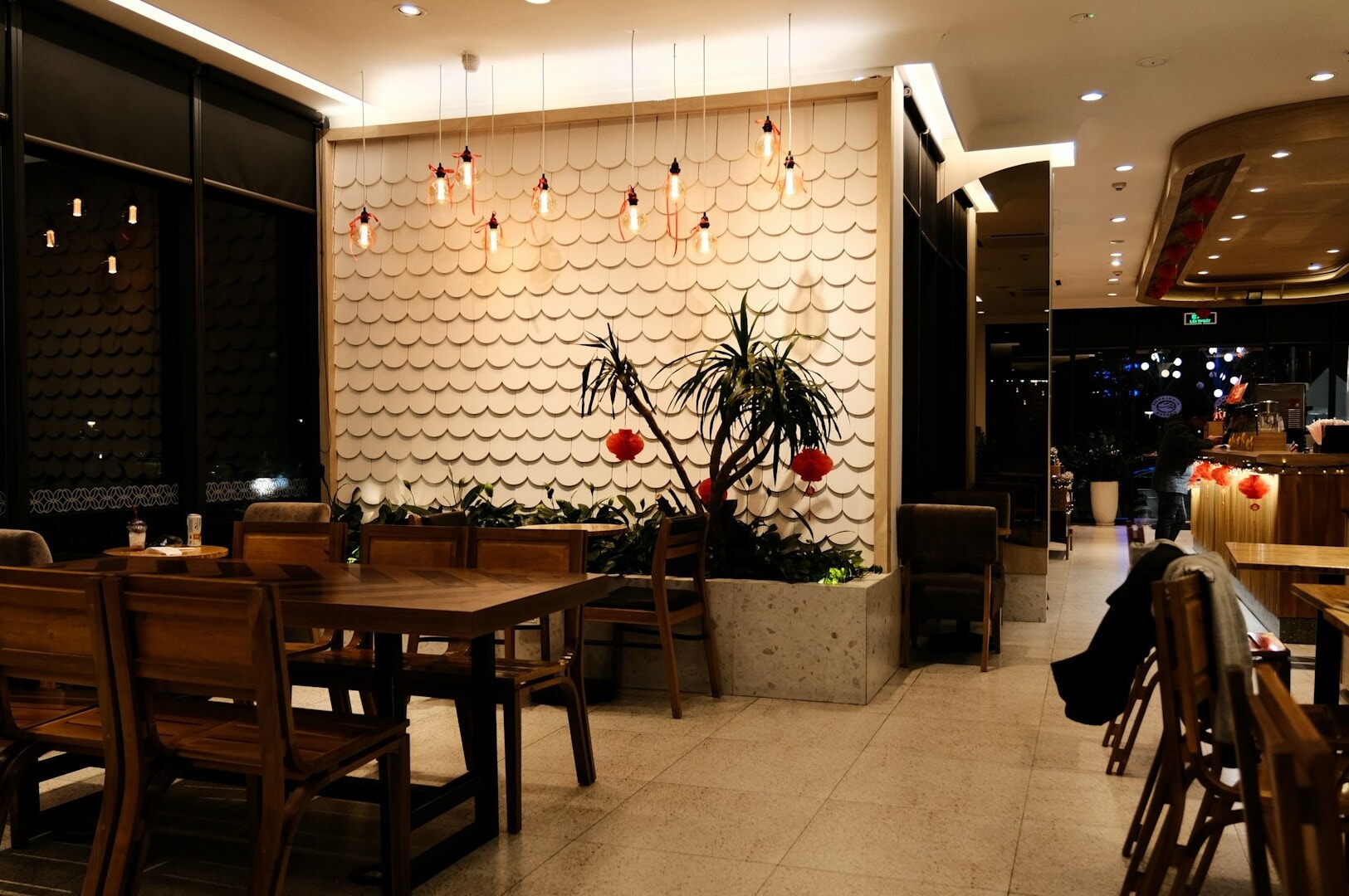 Interior of a fine dining restaurant in Singapore, with polished wooden tables and chairs arranged for an upscale experience.