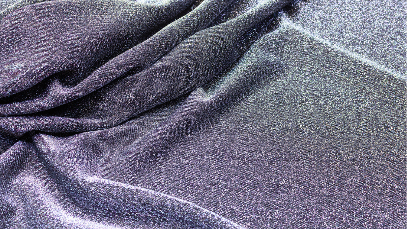 A close-up image of a dark gray rayon fabric