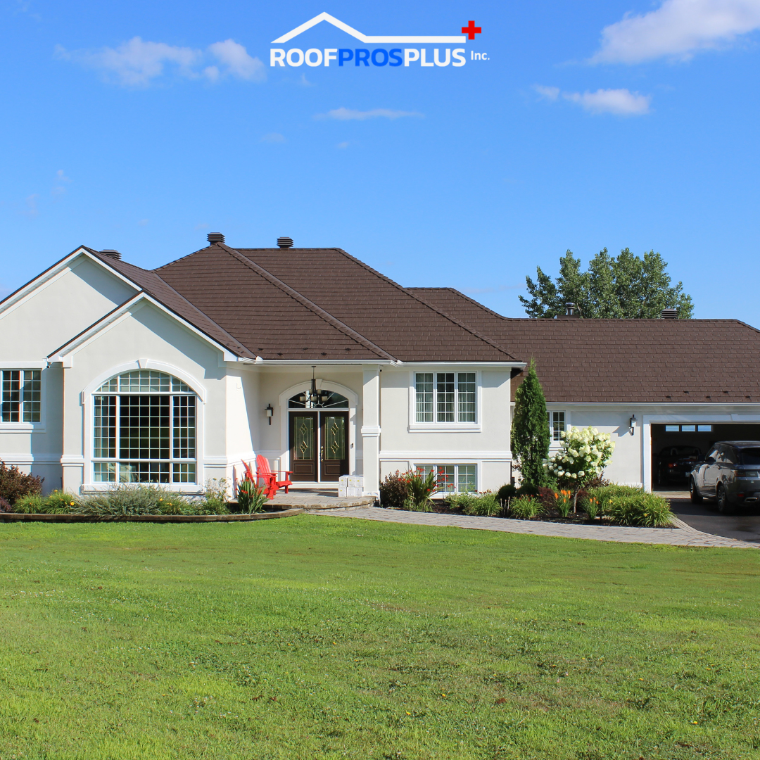 A large home with a newly installed brown metal roof, set on a perfectly manicured lawn.