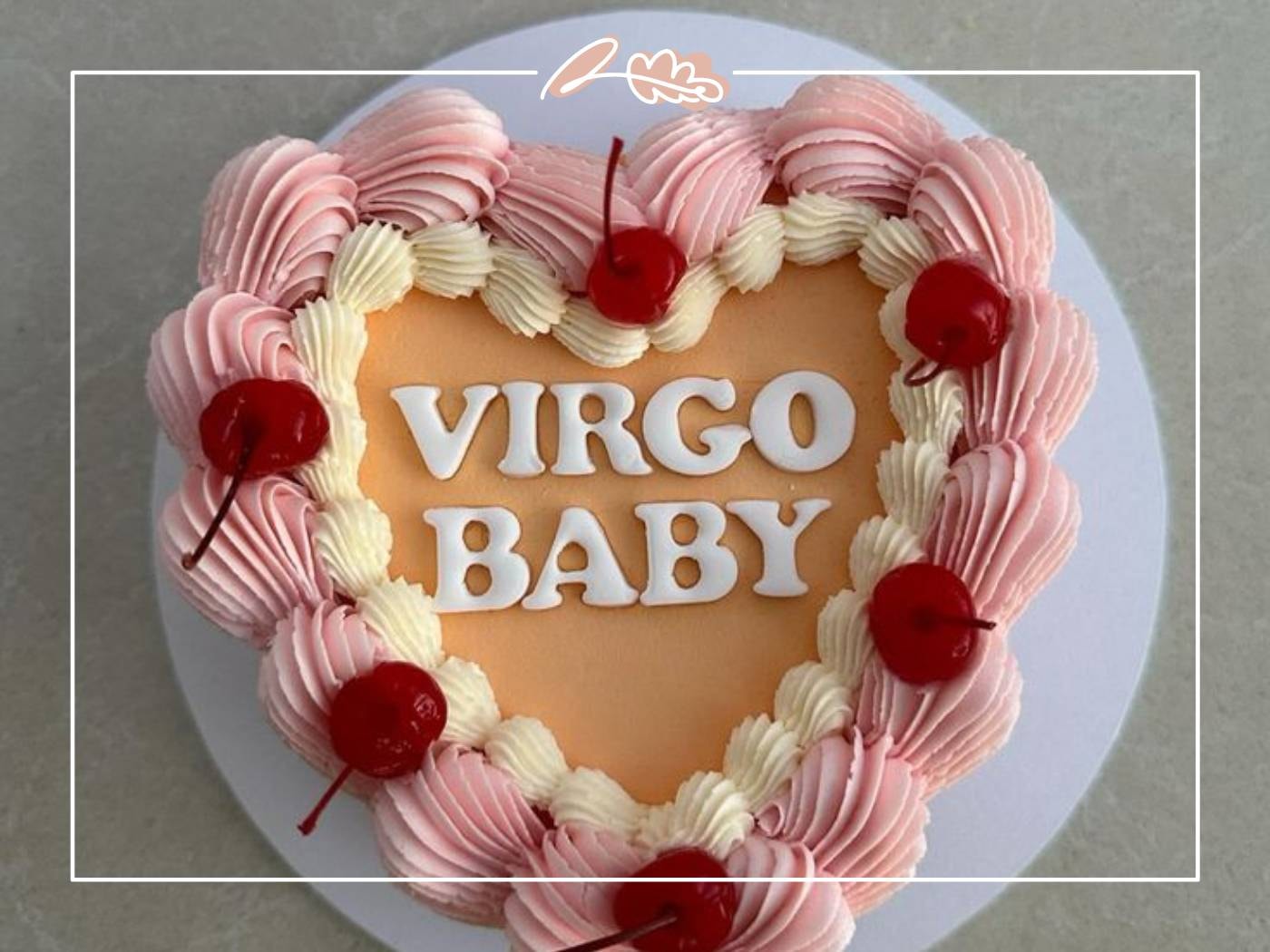 A heart-shaped cake with pink frosting and cherries, decorated with the words "Virgo Baby" - Fabulous Flowers and Gifts