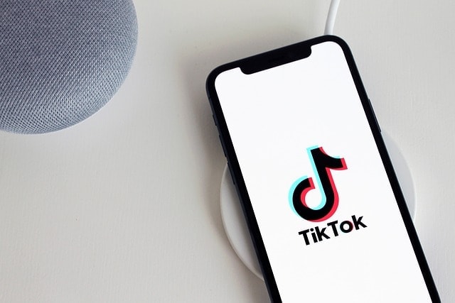 TikTok app on a smartphone, representing a platform for promoting OnlyFans through creative videos.