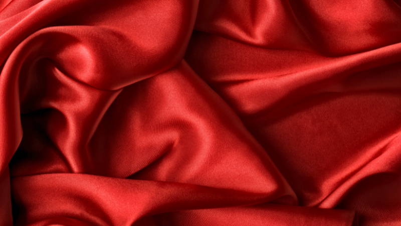 A close-up image of a red Cupro fabric