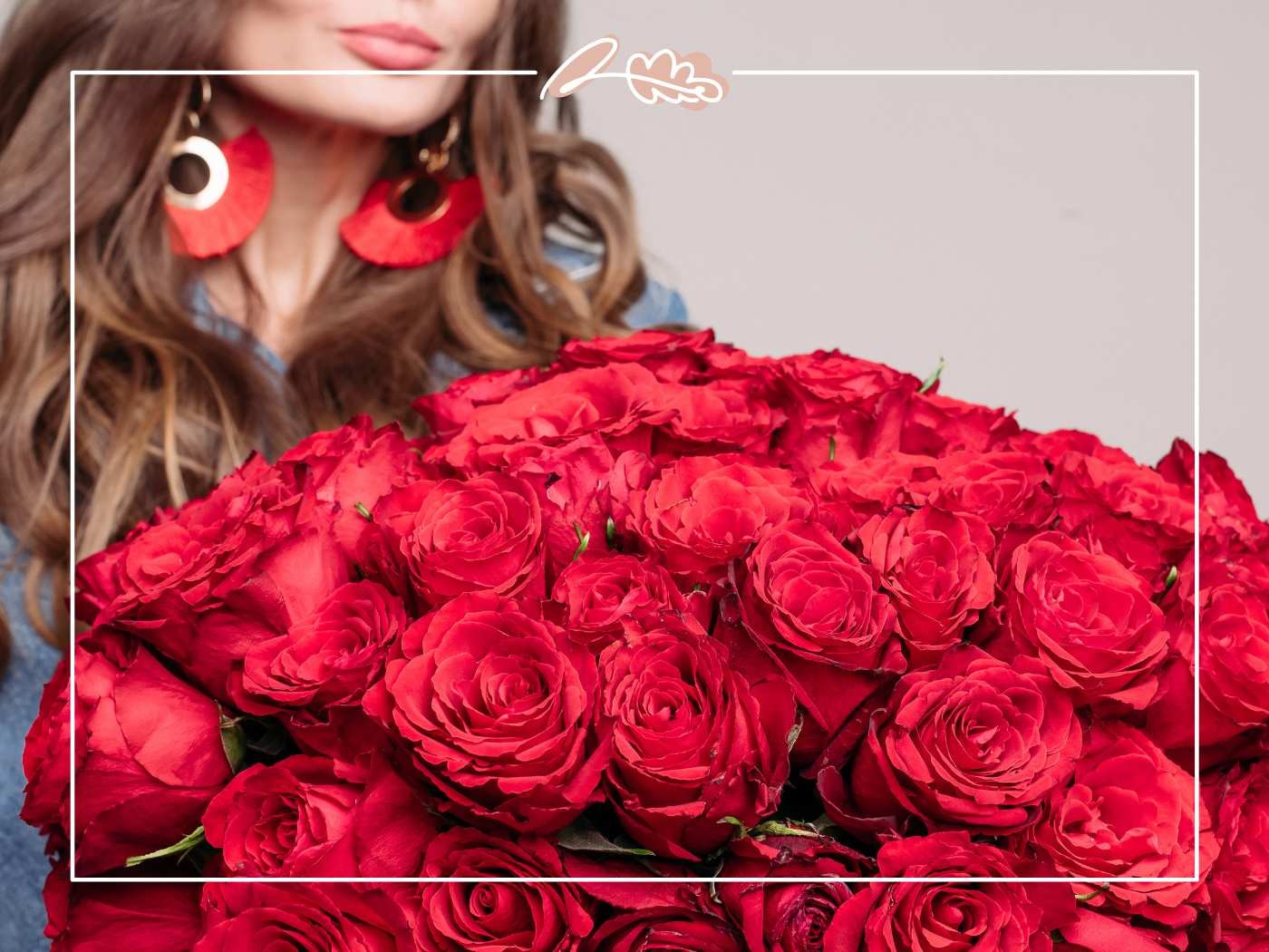 Close-up of abundant red roses held by woman in red statement earrings, with Fabulous Flowers border.