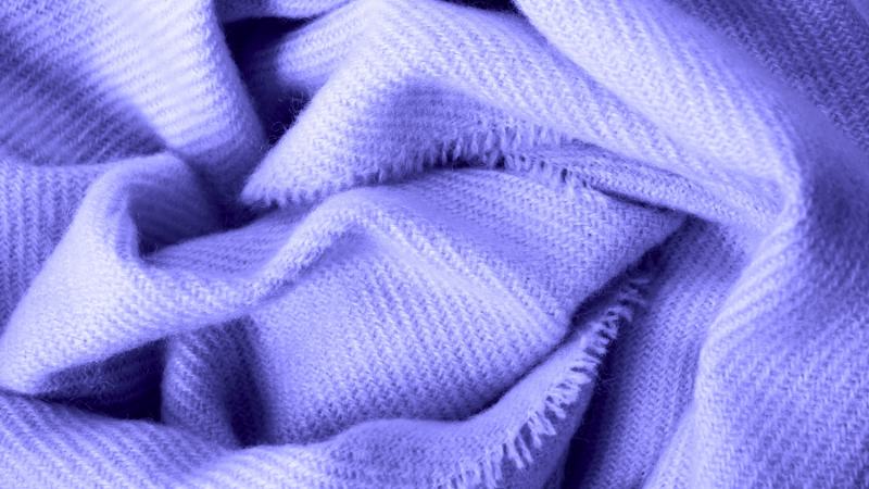 A close up image of a purple acrylic blanket