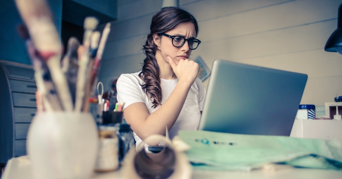 Woman at a desk, thinking, How do I get tax write-offs on OnlyFans?