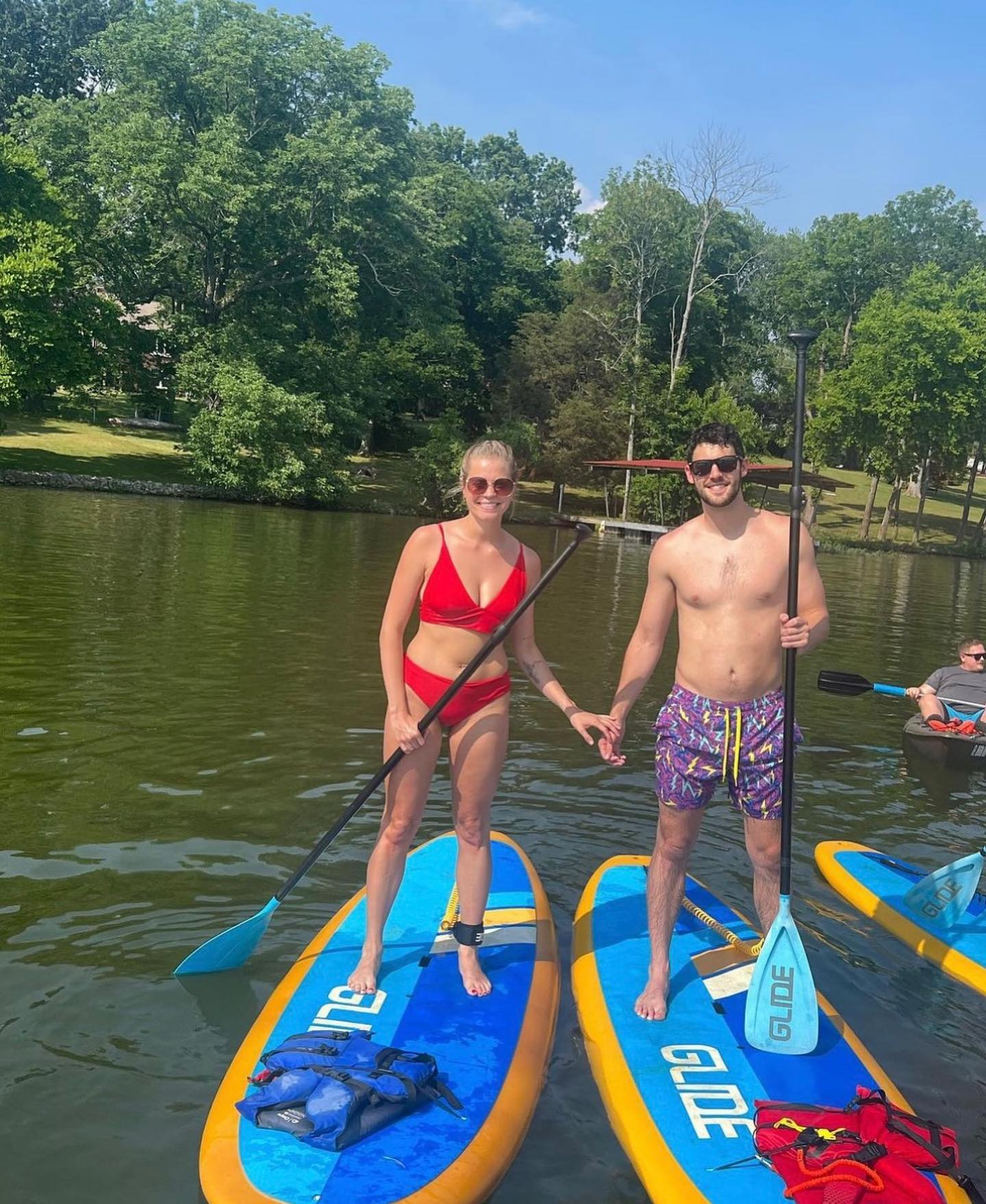 couple on stand up paddle boards