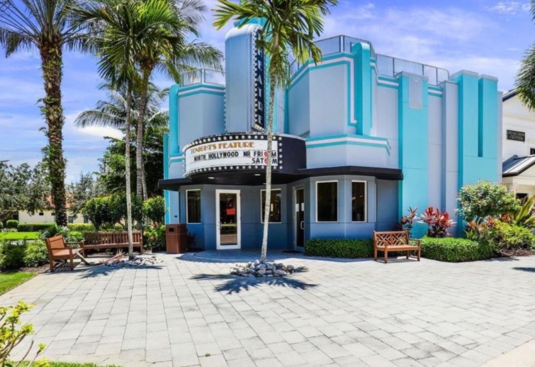 The image showcases a resort-style swimming pool area surrounded by lush palm trees, with a stylish clubhouse in the background, embodying the luxurious lifestyle of the prestigious Paseo community in Fort Myers, FL. This inviting space highlights the beautiful amenities that make resort-style living truly enjoyable.