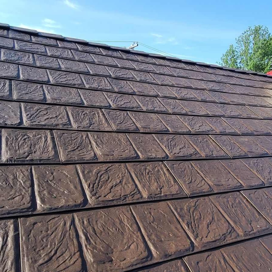 A close-up view of a brown metal roof, highlighting its smooth texture and contemporary appearance.