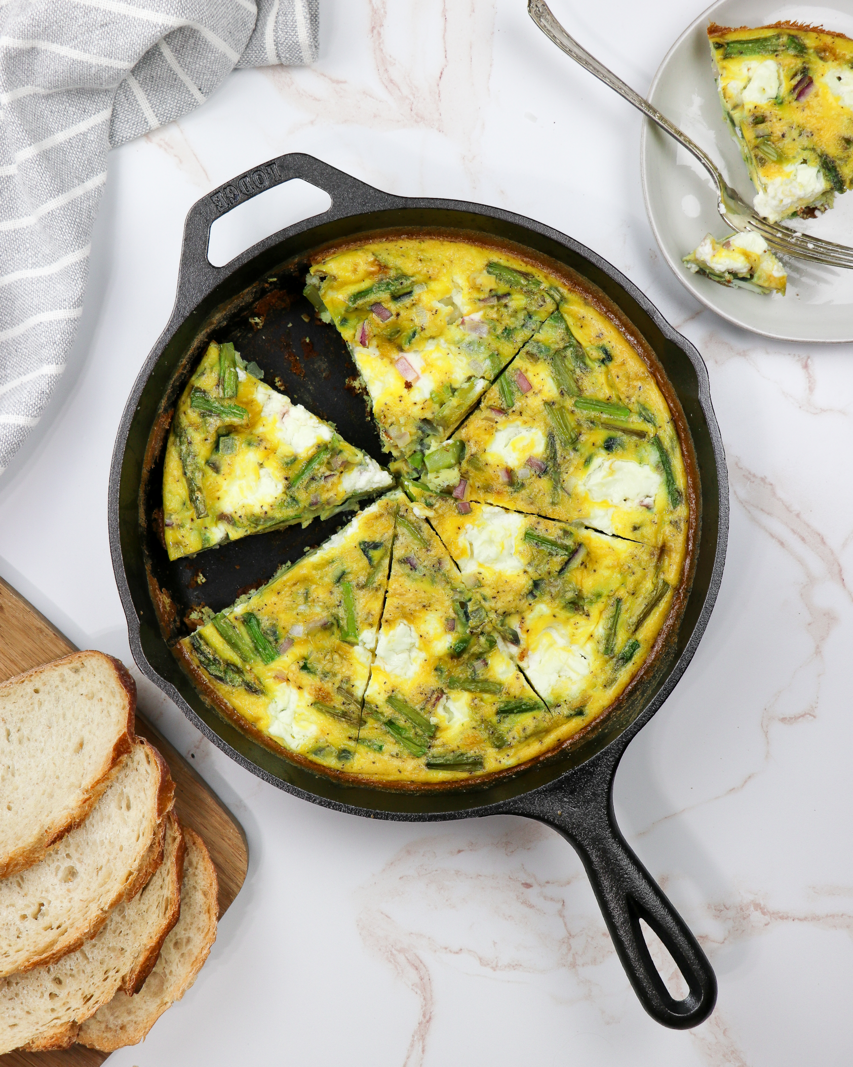 A veggie-packed frittata with wheat bread, mozzarella, and asparagus