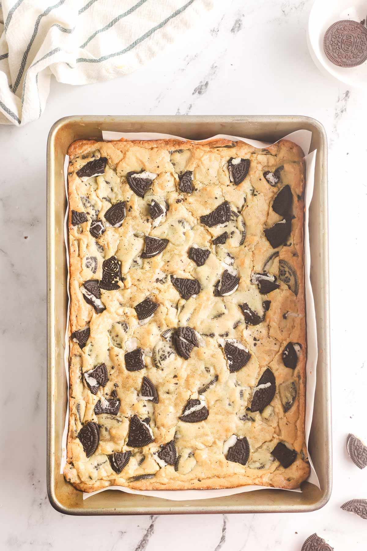 baked Oreo blondies in a parchment paper lined pan