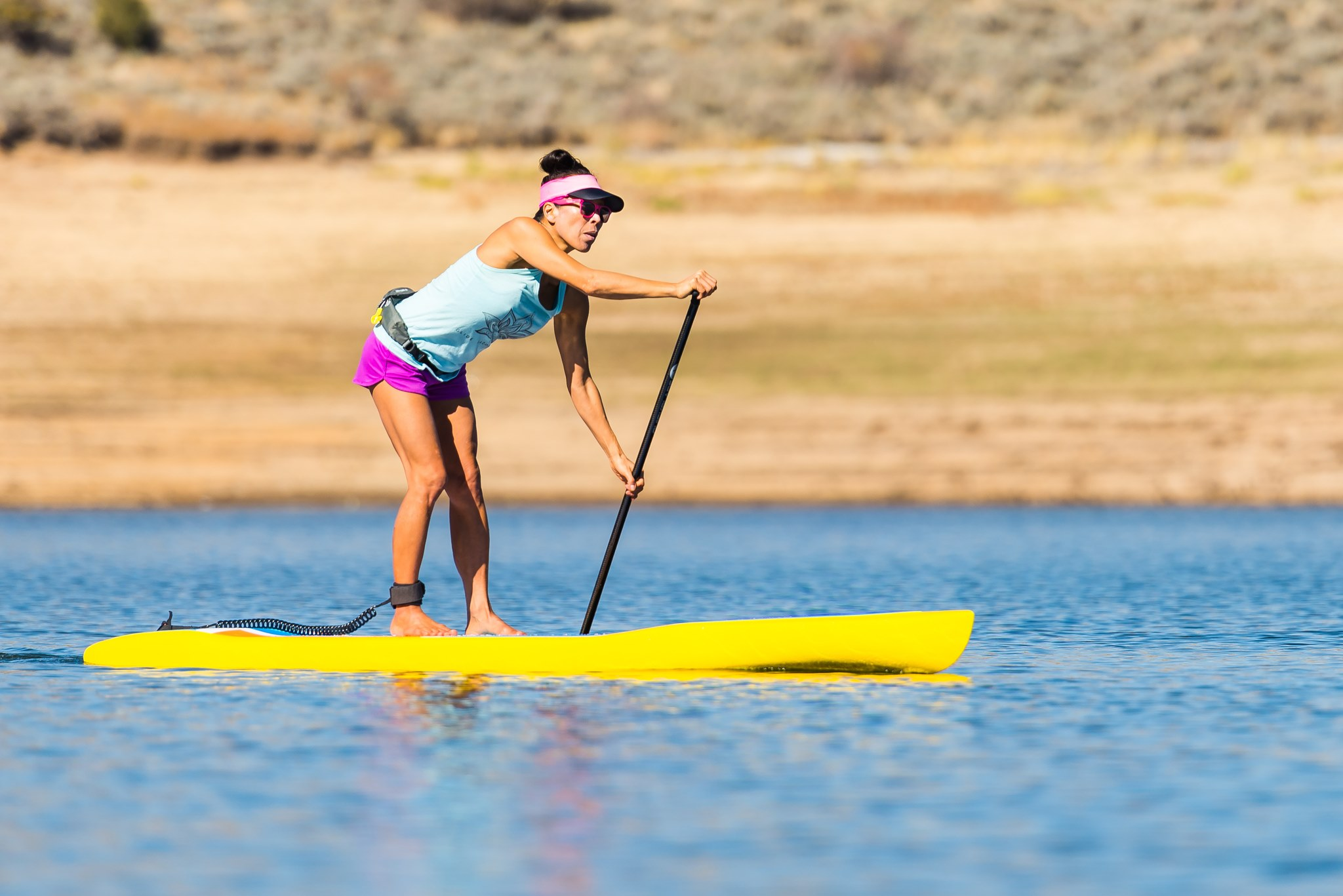 woman paddling a stand up paddle board