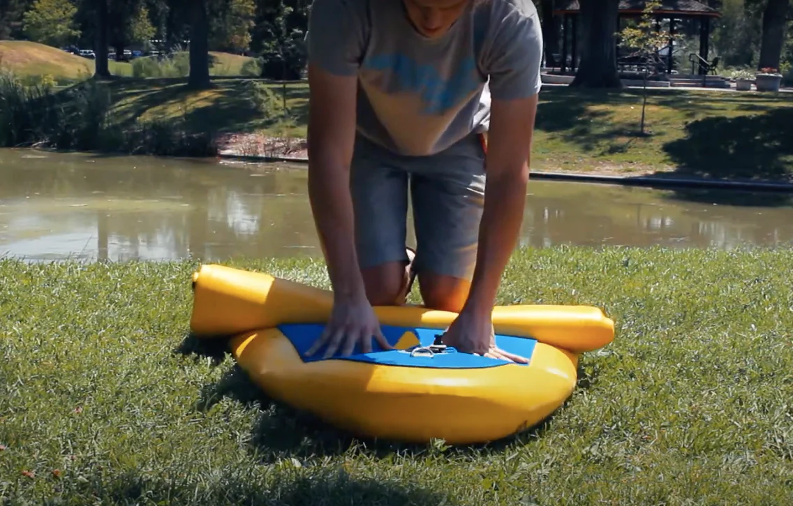 rolling up an inflatable paddle board