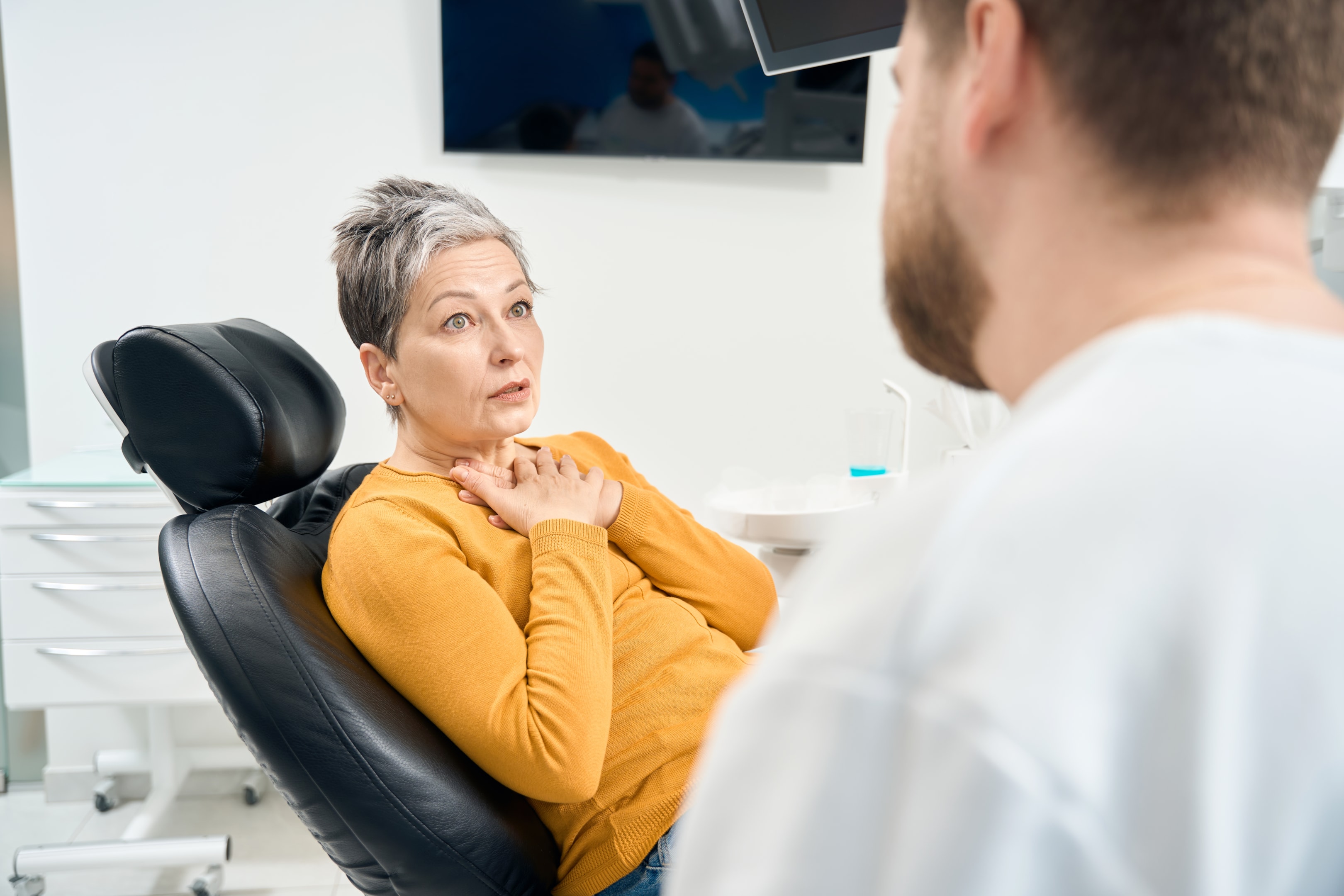 Woman in patient chair getting told she needs speech therapy for her submucous cleft palate