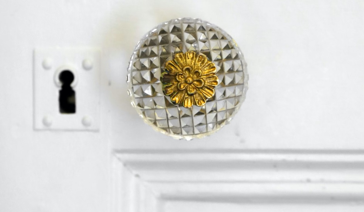 Edwardian geometric glass door knob with bronze flower centre design