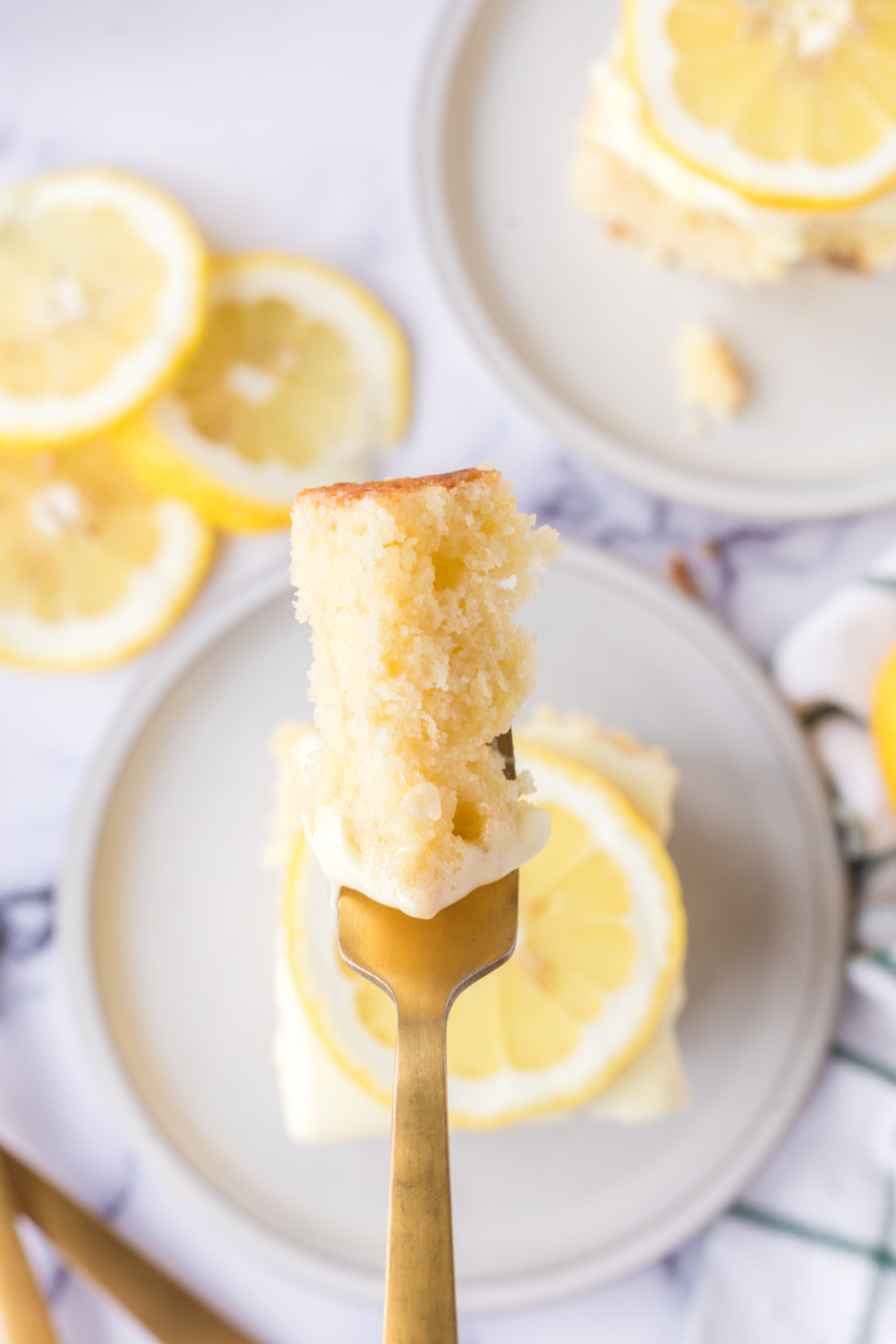fork with a bite of lemon sheet cake 
