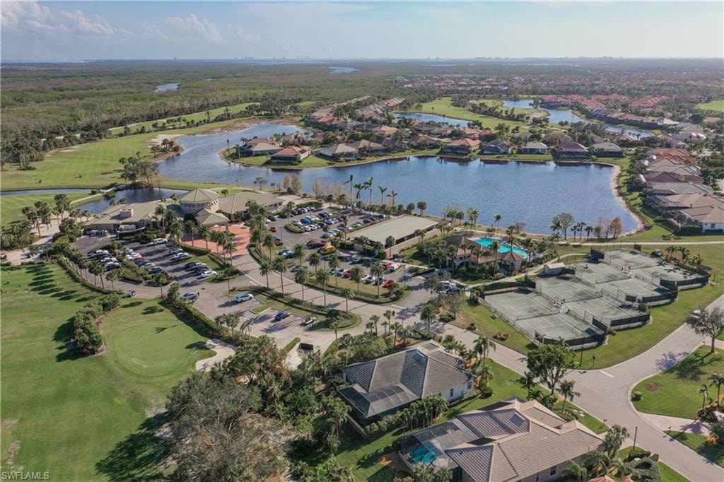 The image shows a professional real estate office consultation in Fort Myers, FL, featuring Crown Colony property listings prominently displayed. The setting conveys a welcoming atmosphere where prospective property consumers can explore new listings and gather information about homes for sale in the Crown Colony community.