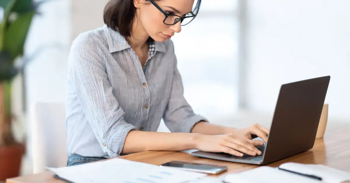 Woman checking a CP501 balance against IRS payment records before responding.