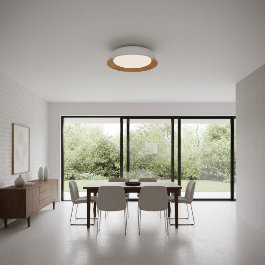 Dining room lit by a flush-mount ceiling light with a timber trim for even ambient lighting.