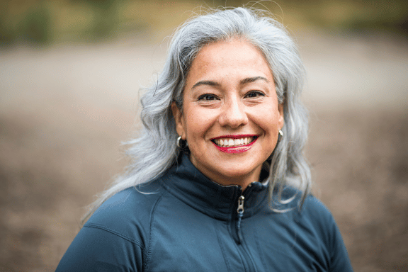 woman smiling showing off her new dental implant 