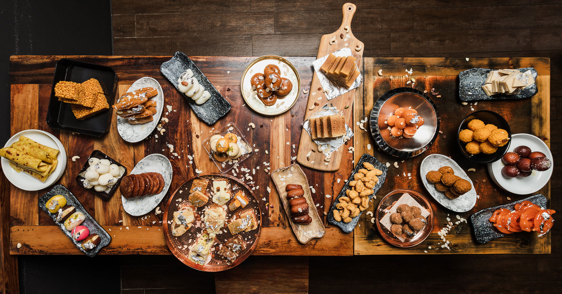 A variety of North Indian sweets displayed on a traditional platter