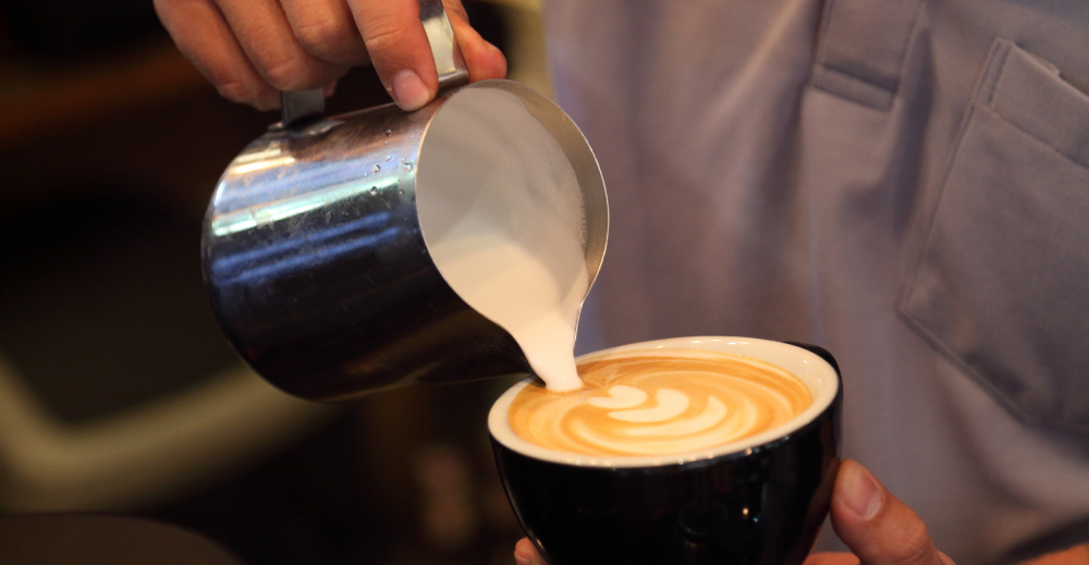 frothing pitcher used to pour frothed milk