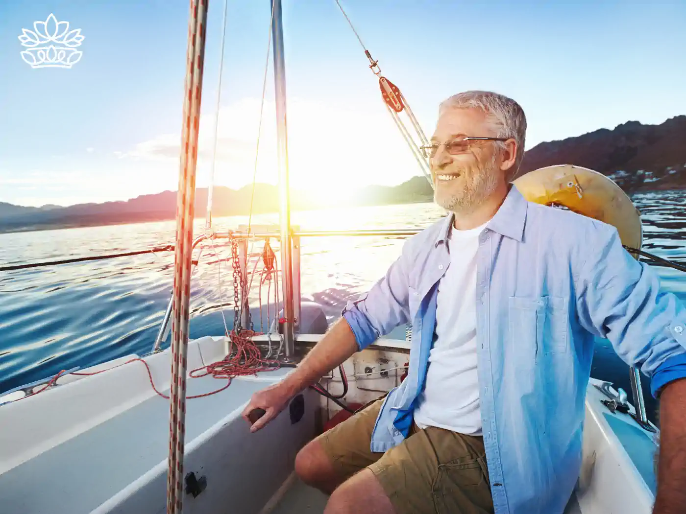 A smiling elderly man sailing on a boat during retirement. Fabulous Flowers and Gifts. Collection: Retirement.