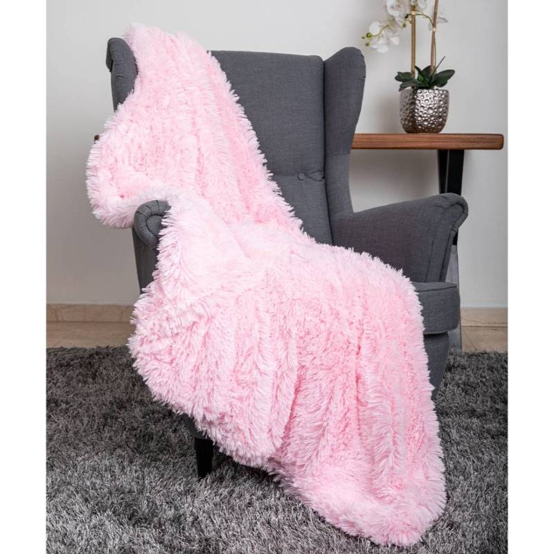 A soft, pink furry blanket is draped over a gray chair, emphasizing How to Keep Dog Blankets Clean