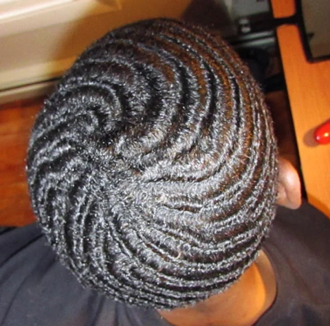 A person moisturizing their hair with a moisturizing shampoo to form deep waves