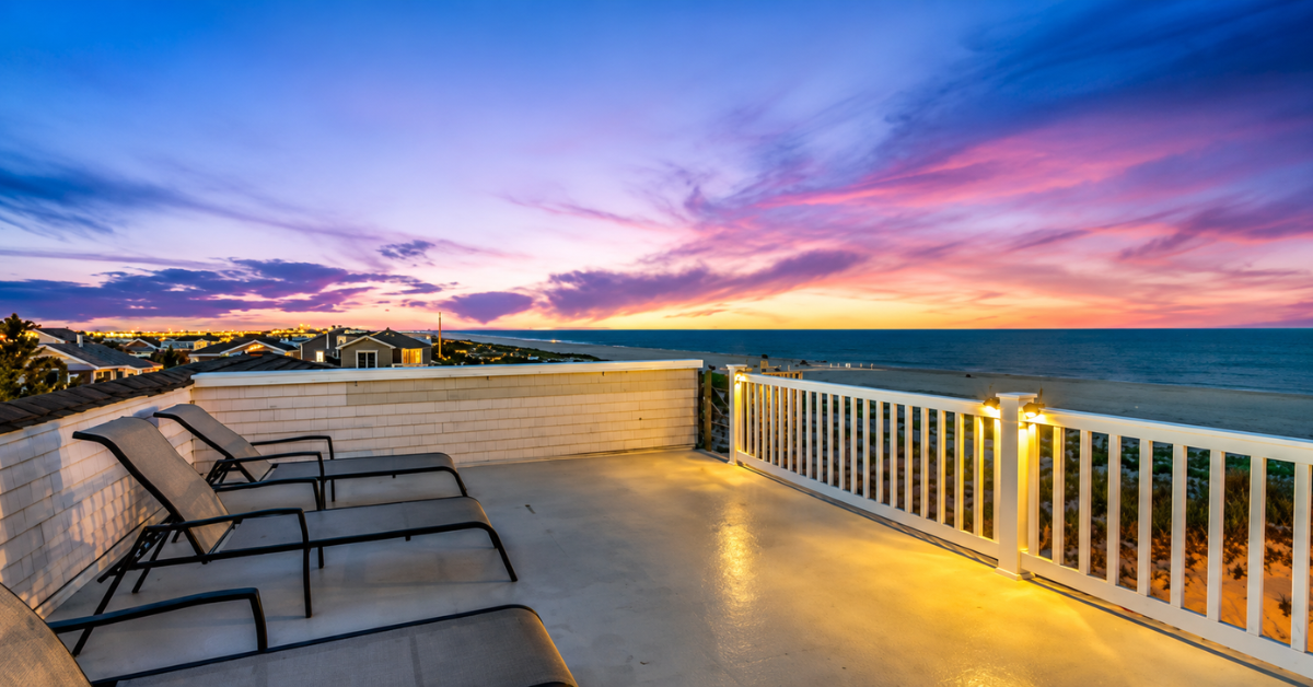 Oceanfront vacation home deck with ocean views and sunset at Ship Bottom, Long Beach Island NJ, showing luxury rental amenities for beachfront getaways