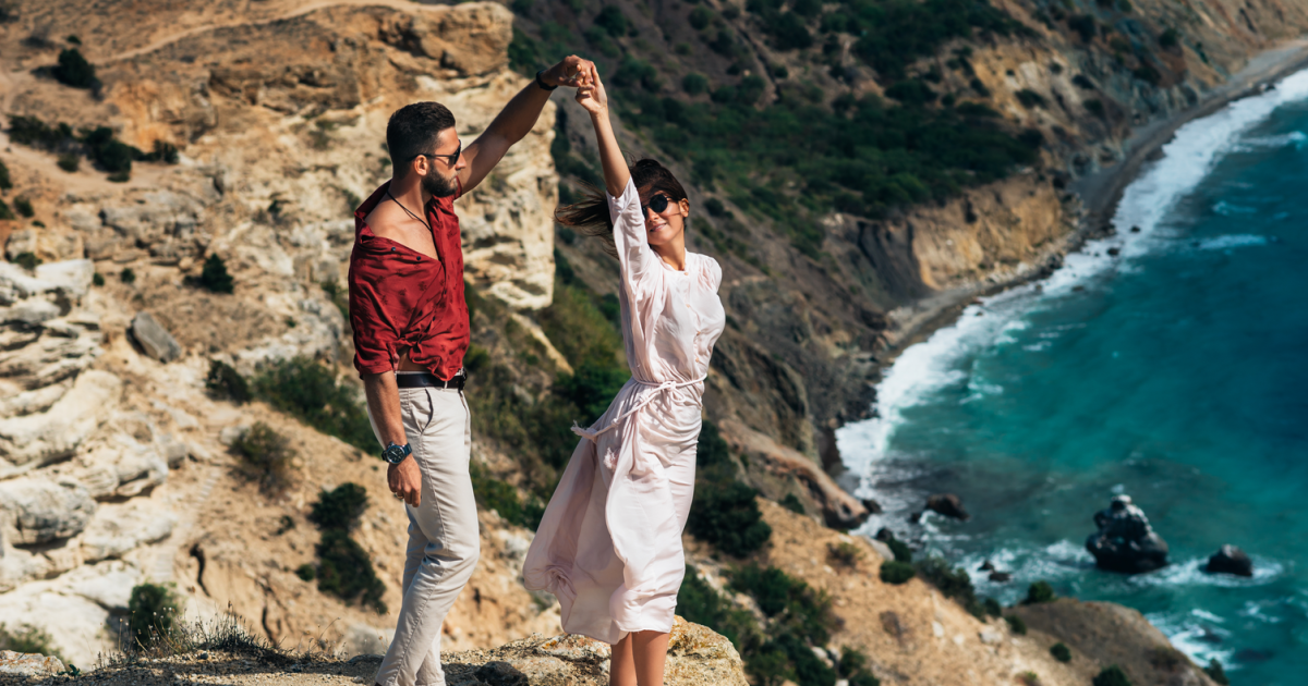 A graceful couple waltzing effortlessly near the ocean after successful marriage therapy for OCPD, their elegant movements in harmony with the gentle waves lapping at the shore, reflecting their renewed connection and understanding.