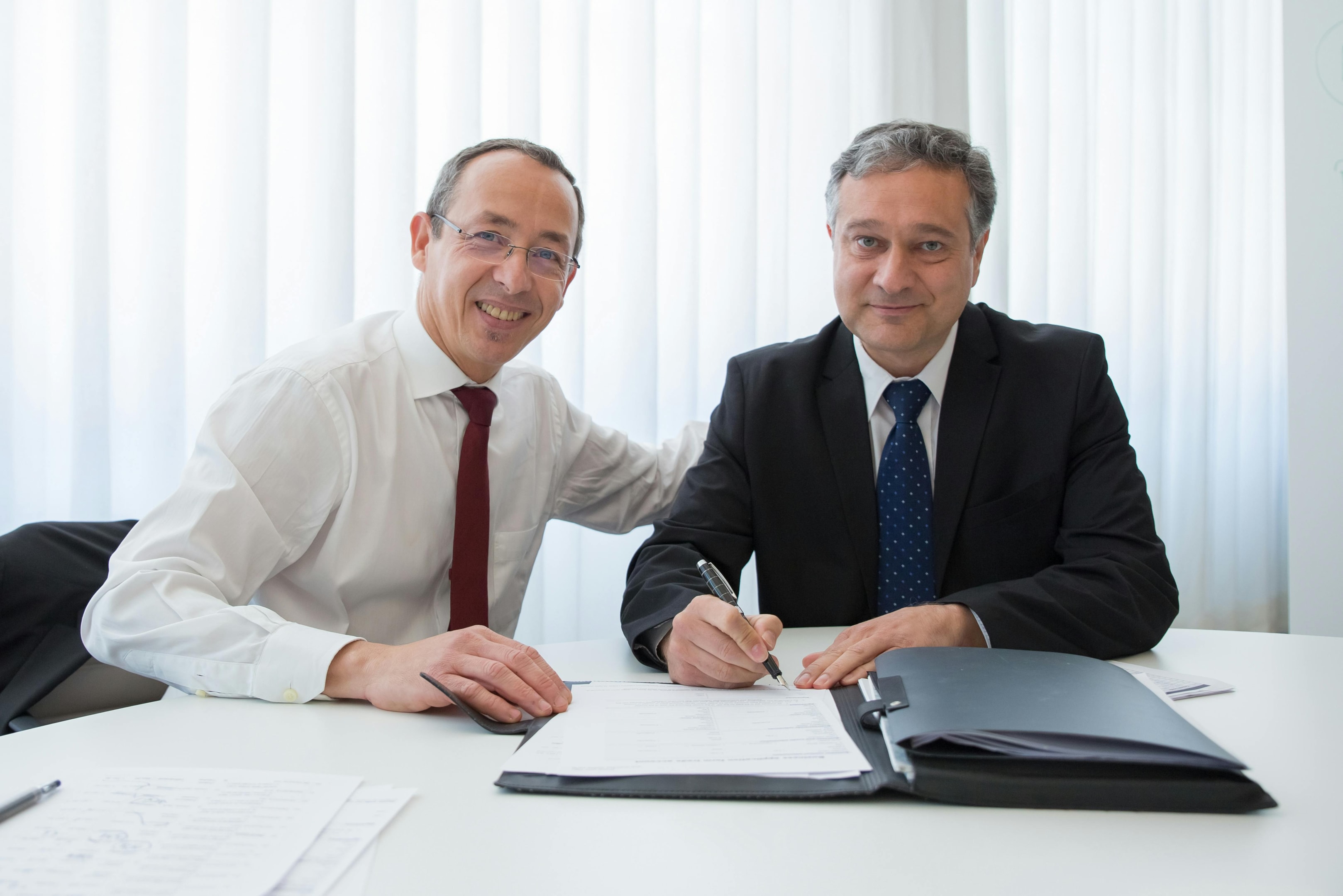 Real estate investors review joint venture paperwork together.